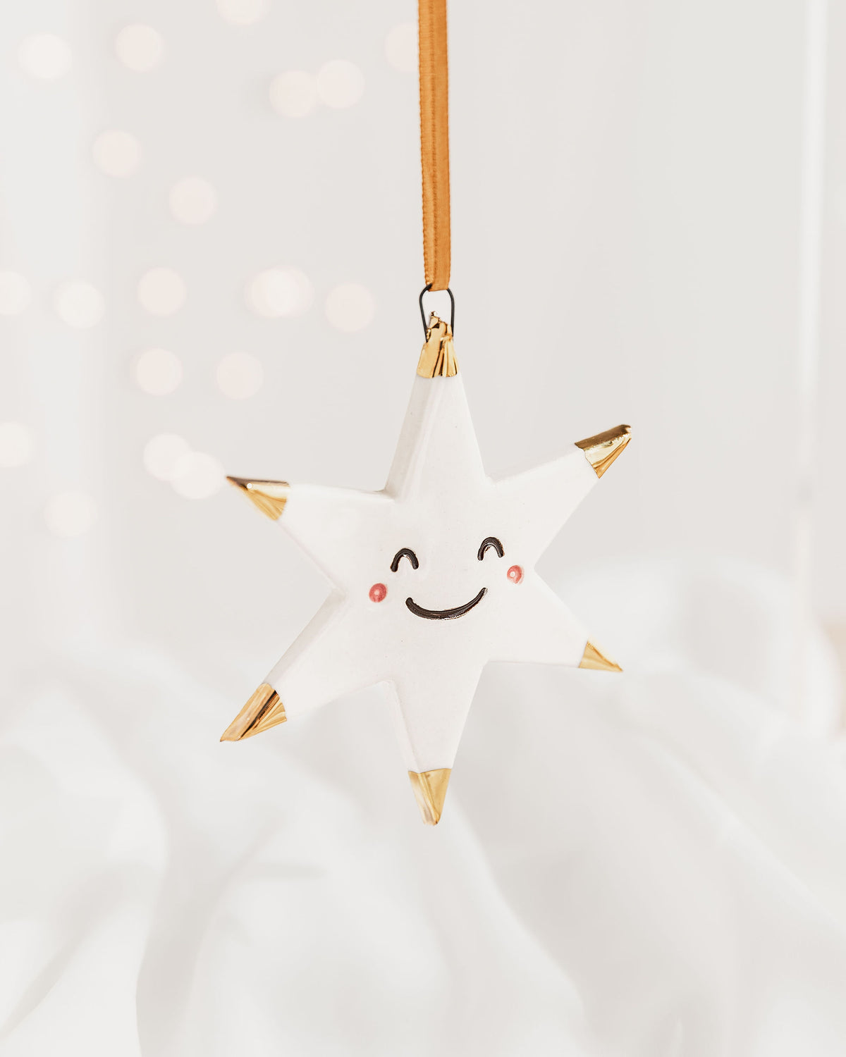 White Star Ceramic Ornament with a smiley face and Gold Tips