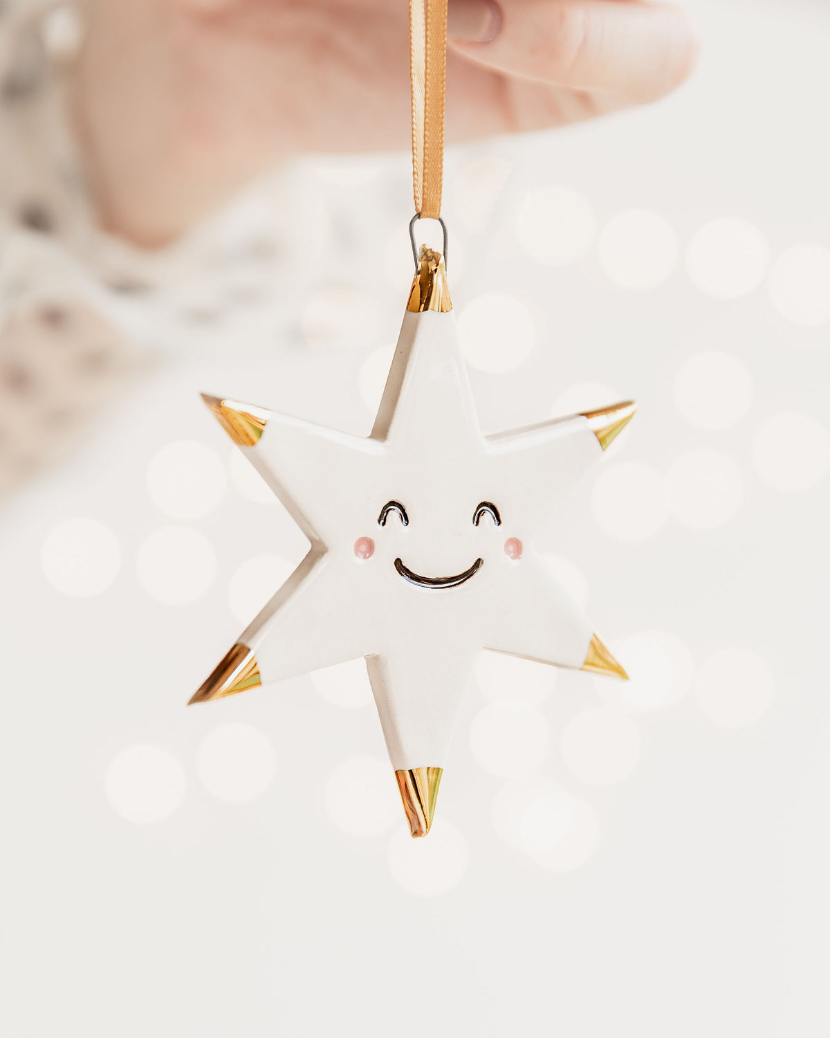 White Star Ceramic Ornament with a smiley face and Gold Tips
