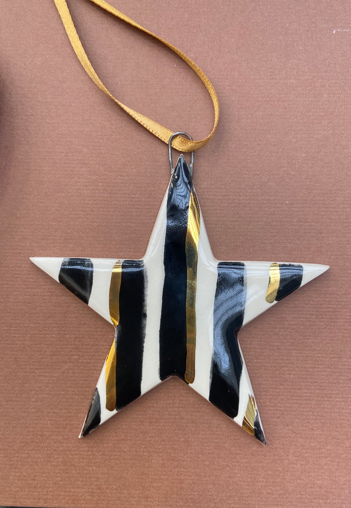 Stripy black and gold star ornament