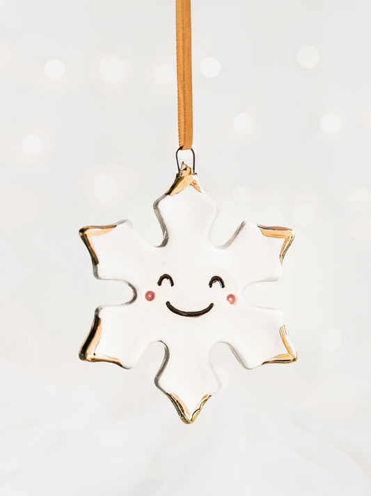 White Snowflake Ceramic Ornament with a smiley face and Gold Tips